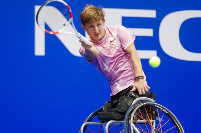 Niels Vink, a Dutch wheelchair tennis player, returns a shot during competition