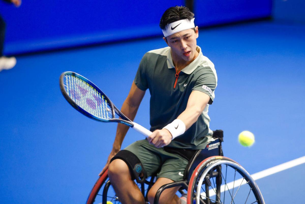 Wheelchair tennis player Tokito Oda plays a backhand