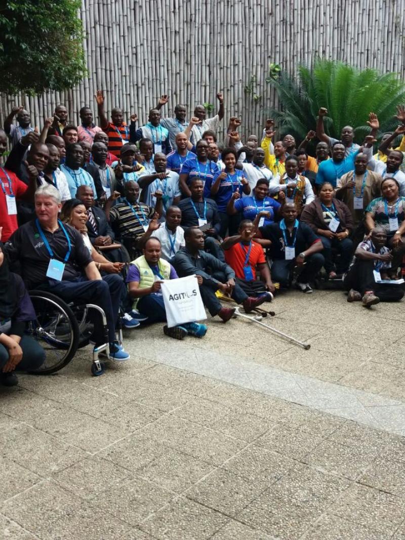 a group of people wave at the camera