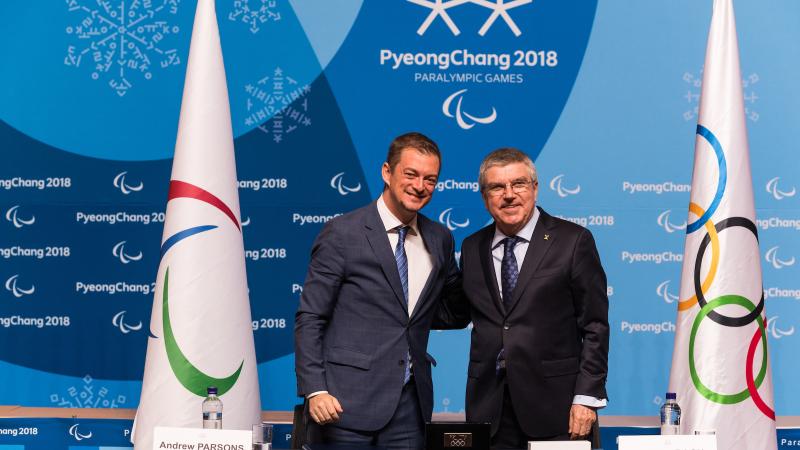 Andrew Parsons and Thomas Bach two men standing and smiling