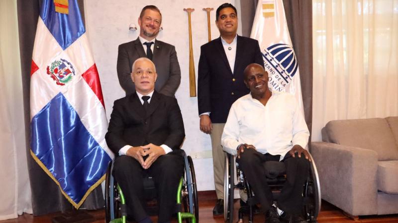 IPC President Andrew Parsons poses for a photo with three male officials