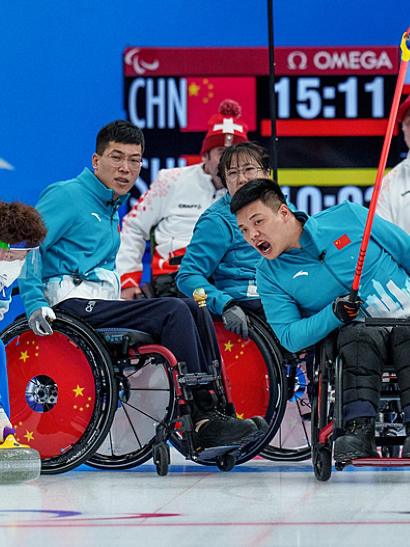 A Chinese wheelchair curlers reacts after releasing a stone