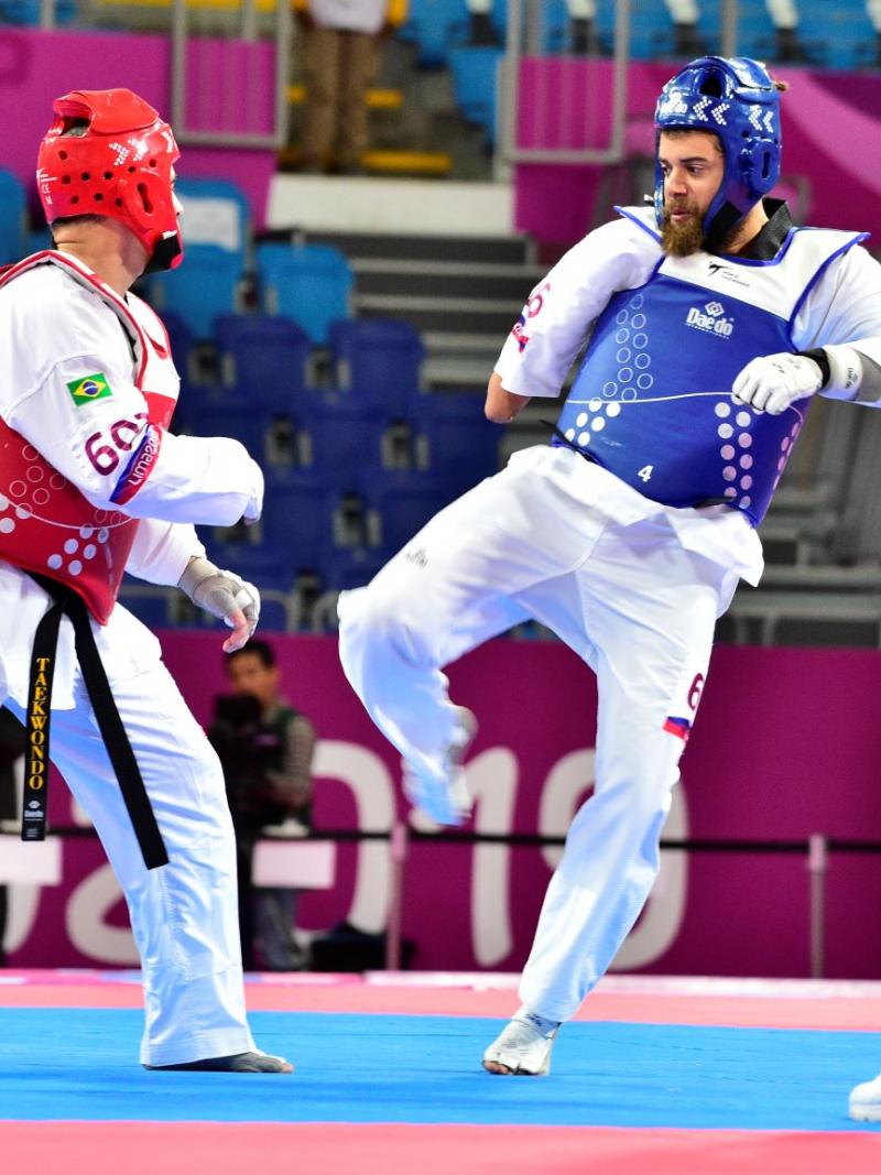 Two male taekwondo fighters sparring