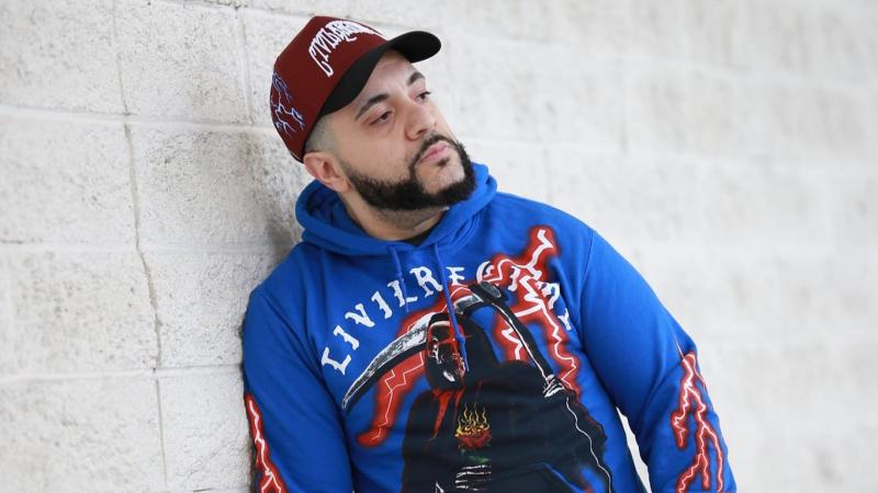 Rising Phoenix rapper George Doman leaning against a wall 