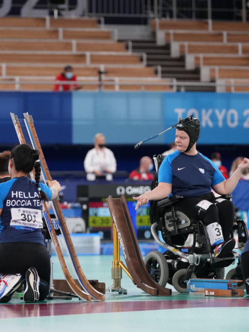 Two boccia athletes are competing in a match at Tokyo 2020 with their sport assistants.