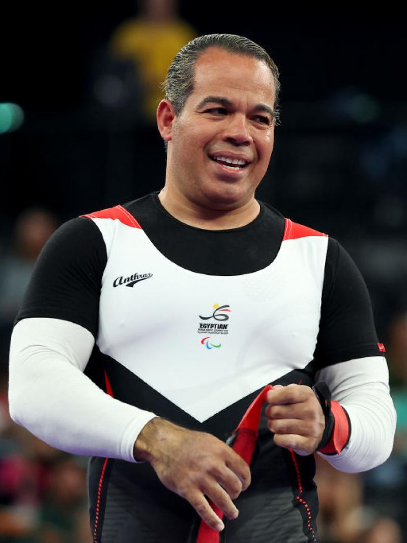 Powerlifter Sherif Osman smiles on stage 