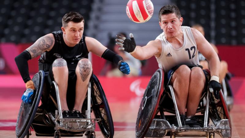 Two male wheelchair rugby players in action