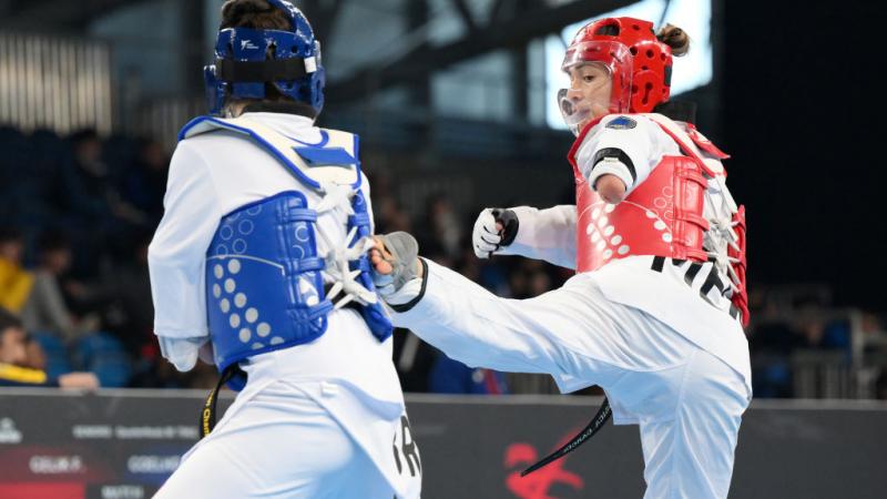 Two female Para taekwondo athletes in action