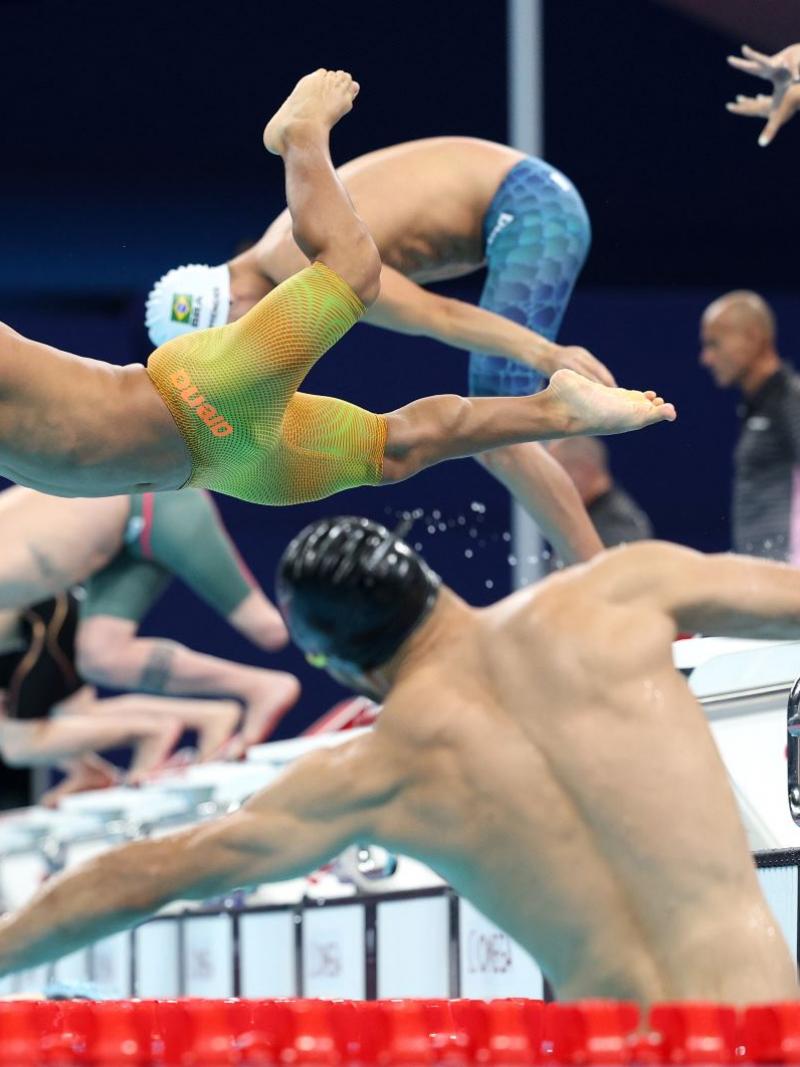 Swimmers jump into the pool to start their campaigns
