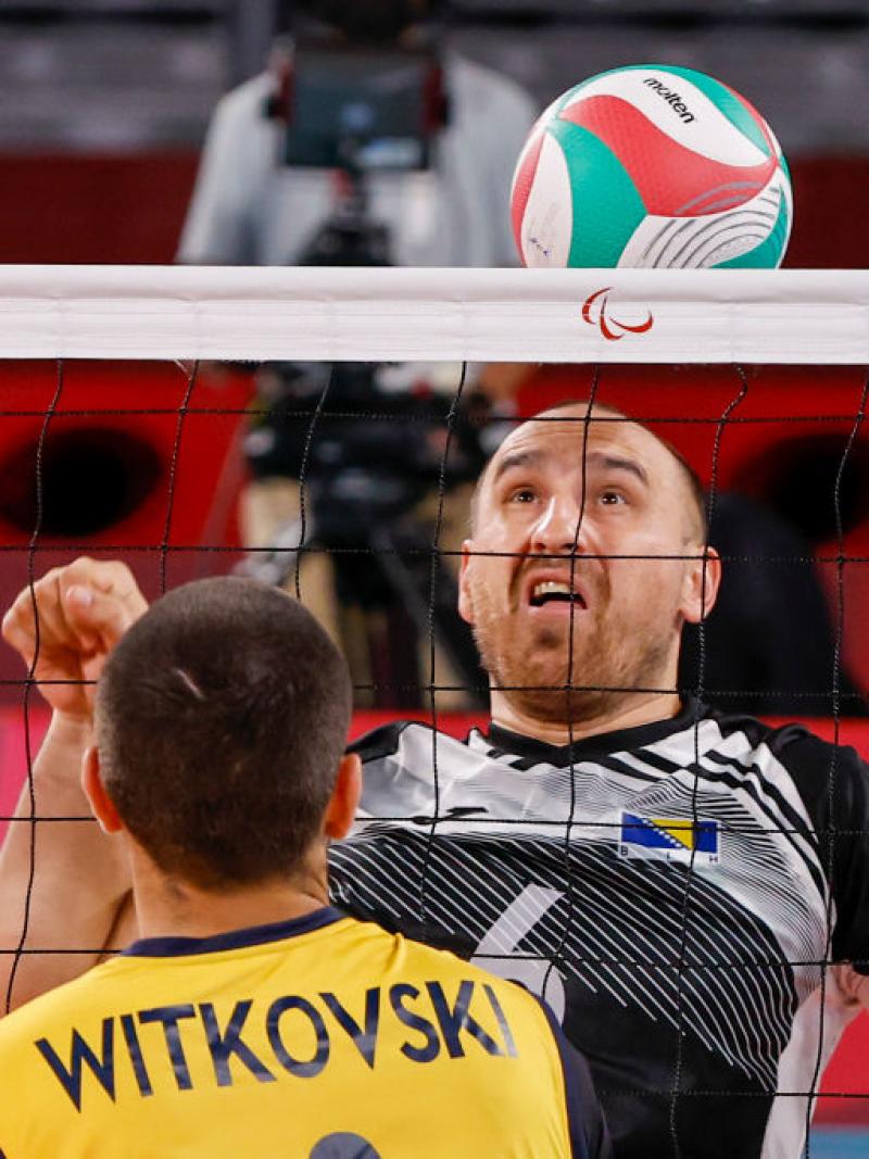 A male athlete reacts in front of the net