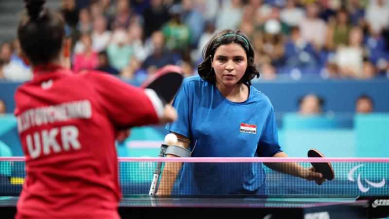 A female Para table tennis player returns a shot