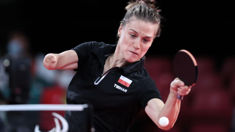 Woman returns ball in table tennis
