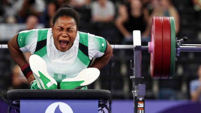 A female Para powerlifter reacts after her lift