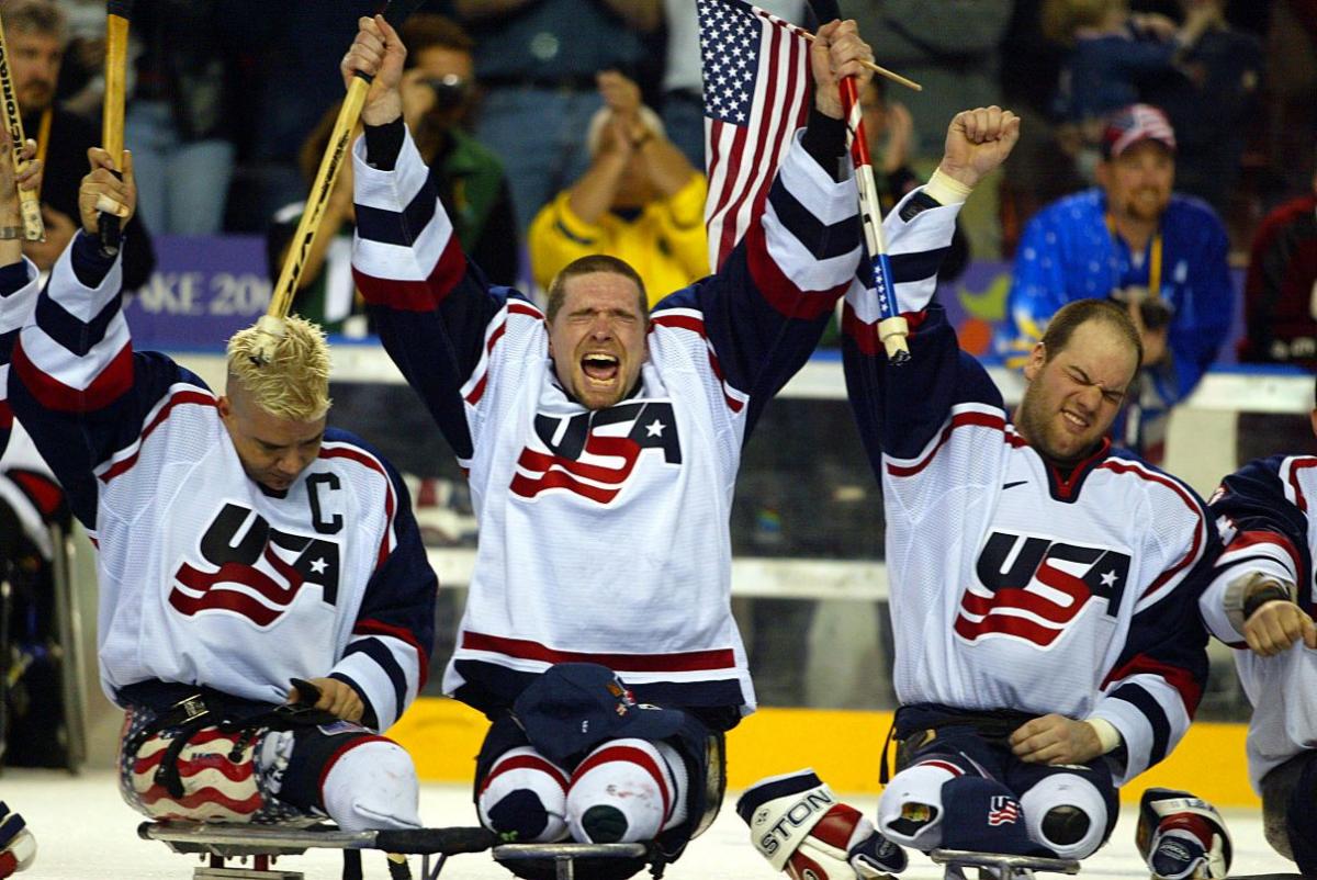 Three USA Para ice hockey players celebrating