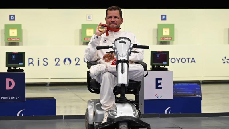 An athlete shows his medal