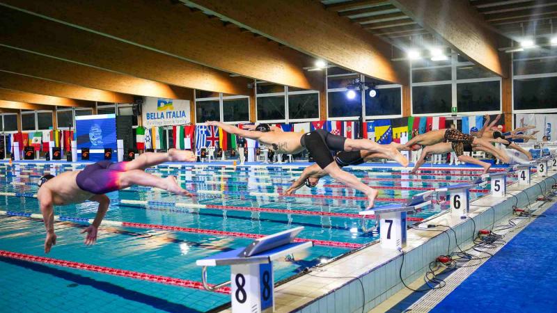 Swimmers jump into the pool to start their campaigns